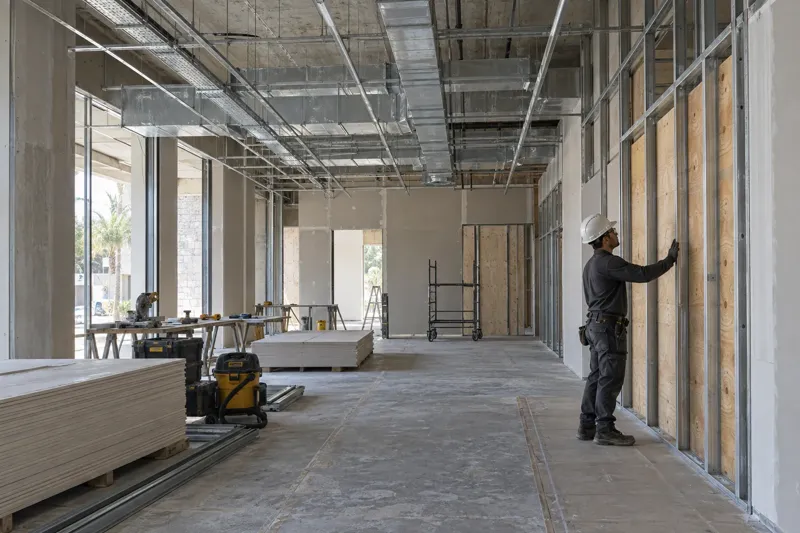 Conceptual image of plywood wall backing and coordinated ceiling ducts and electrical conduits