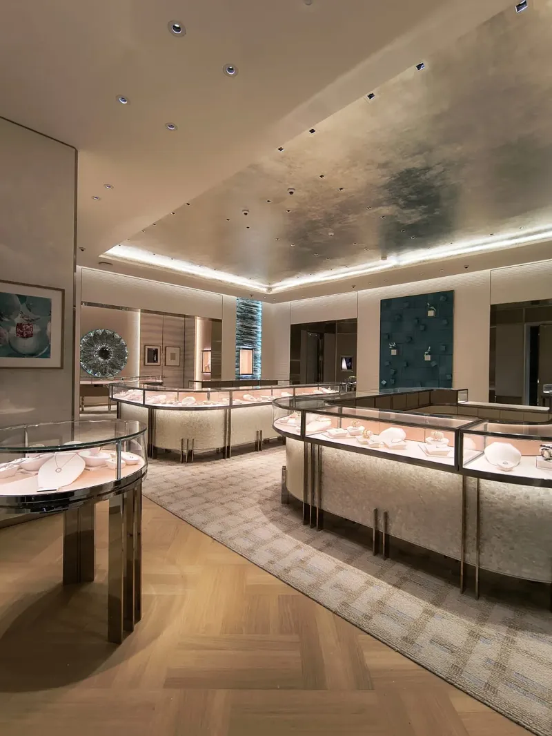 Main room with illuminated showcases and an aqua accent