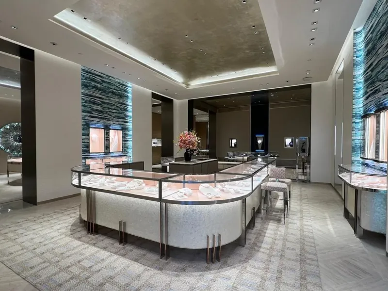 Main jewellery salon with curved showcases and blue-toned walls