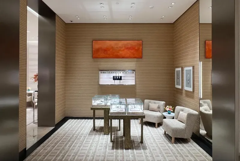 Display room with textured walls and orange-toned artwork